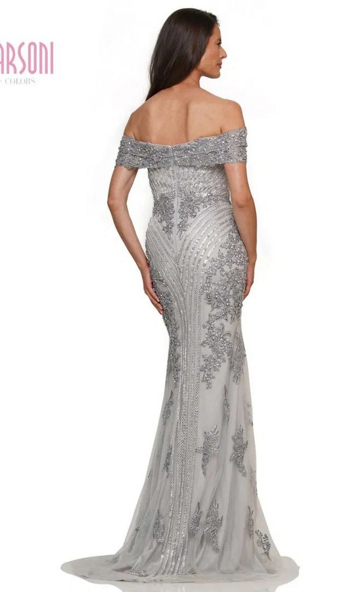 Woman in the Marsoni MV1275 long formal dress, featuring an off-the-shoulder neckline, silver-gray beading, and a fitted floor-length silhouette, elegantly photographed from the back.